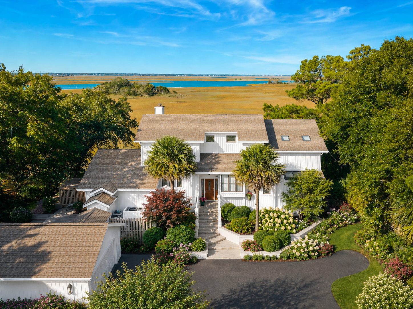 AI concept of 10 Waterway Island Drive from above, with refreshed white board-and-batten exterior and the marsh and Intracoastal beyond